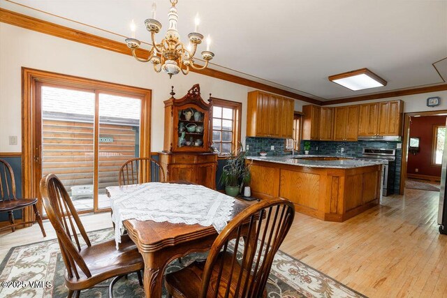 336 E Fourth St, Eagle, CO 81631 - dining room featuring a chandelier, ornamental molding, plenty of natural light, and light wood-type flooring