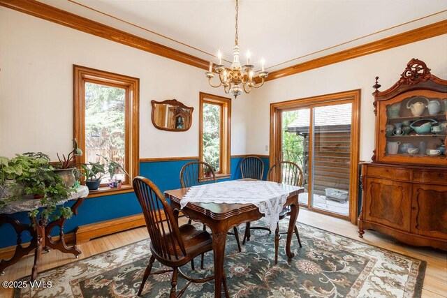 336 E Fourth St, Eagle, CO 81631 - dining space with a chandelier, light wood-style floors, crown molding, and wainscoting