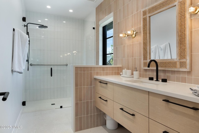 1092 Fourth Of July Rd, Eagle, CO 81631 - bathroom featuring tile walls, a tile shower, vanity, tile patterned floors, and tasteful backsplash