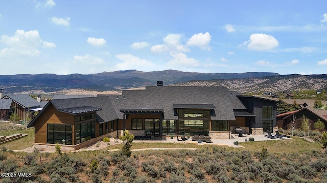 1092 Fourth Of July Rd, Eagle, CO 81631 - back of house featuring a patio area, a mountain view, and a standing seam roof