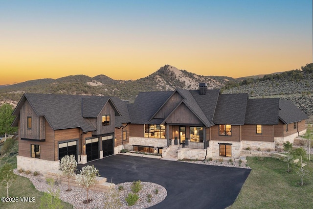 1092 Fourth Of July Rd, Eagle, CO 81631 - contemporary house with stone siding, driveway, a mountain view, and a chimney