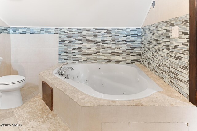 26 Lark Ct Unit B, Eagle-Vail, CO 81620 - full bath with a jetted tub, tile walls, toilet, and tile patterned floors