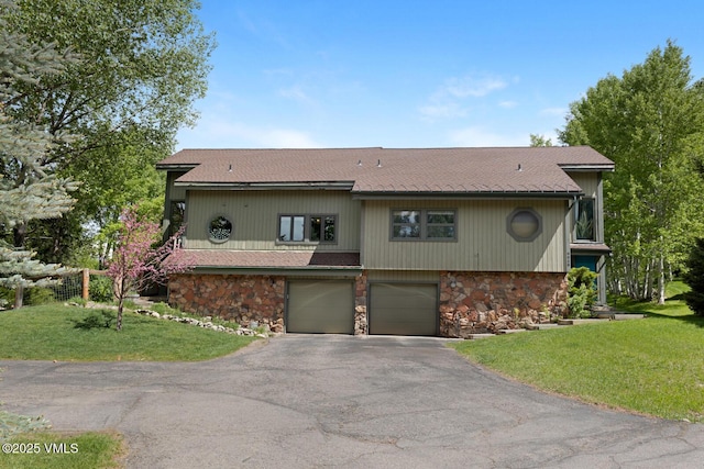 26 Lark Ct Unit B, Eagle-Vail, CO 81620 - view of front of house featuring stone siding, driveway, an attached garage, and a front lawn