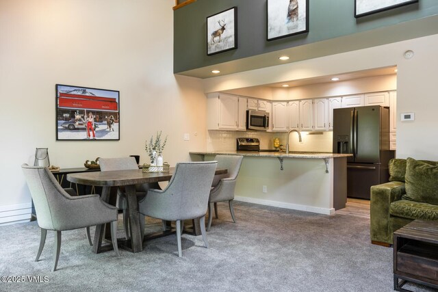26 Lark Ct Unit B, Eagle-Vail, CO 81620 - dining space with carpet flooring, a towering ceiling, recessed lighting, and baseboards
