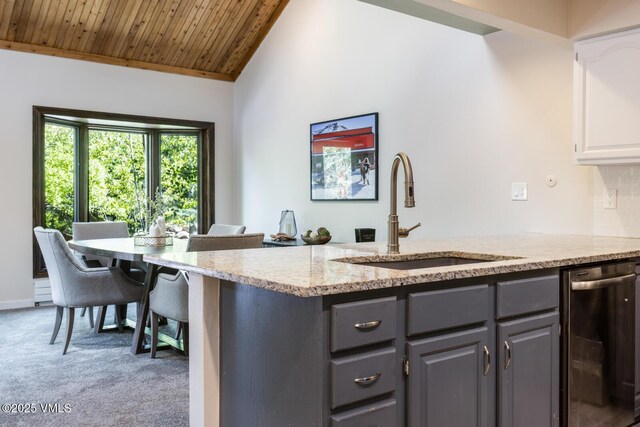 26 Lark Ct Unit B, Eagle-Vail, CO 81620 - kitchen featuring a sink, stainless steel dishwasher, gray cabinetry, carpet floors, and vaulted ceiling