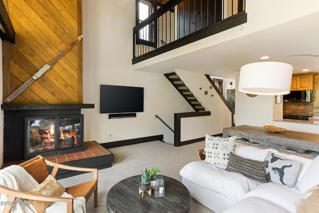 carpeted living room with a high ceiling