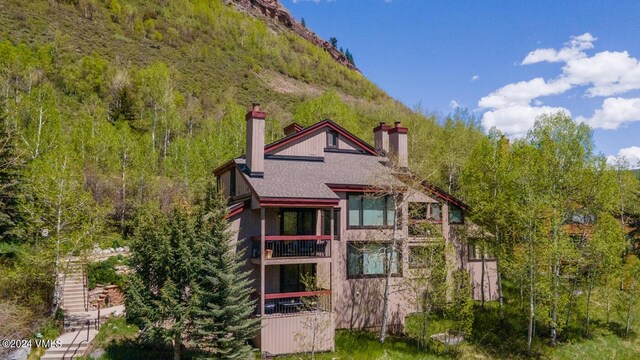 rear view of property featuring a mountain view