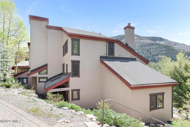 view of property exterior with a mountain view