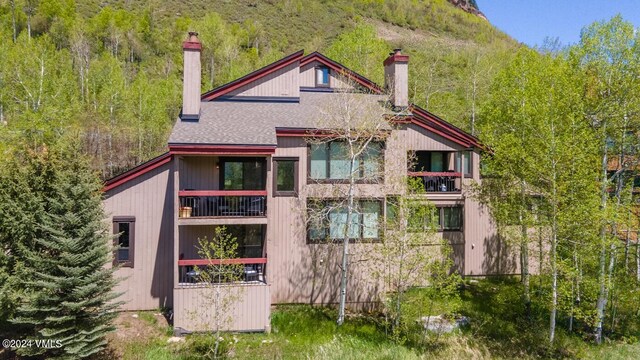 back of house with a balcony