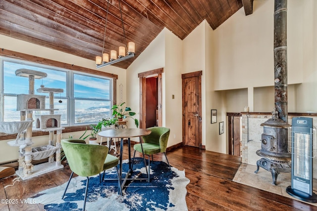 dining area with high vaulted ceiling, hardwood / wood-style floors, wooden ceiling, and baseboards