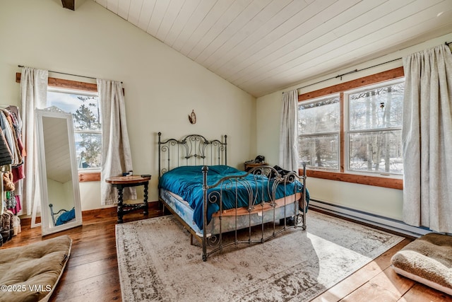 bedroom with a baseboard heating unit, vaulted ceiling, wood-type flooring, and wooden ceiling