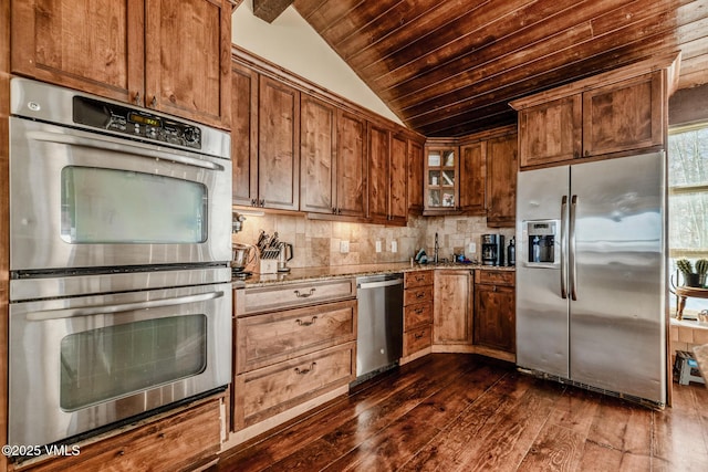 kitchen with light stone counters, wooden ceiling, stainless steel appliances, vaulted ceiling, and backsplash