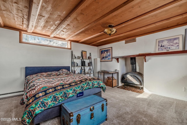 bedroom with carpet floors, a baseboard radiator, visible vents, a wood stove, and wooden ceiling