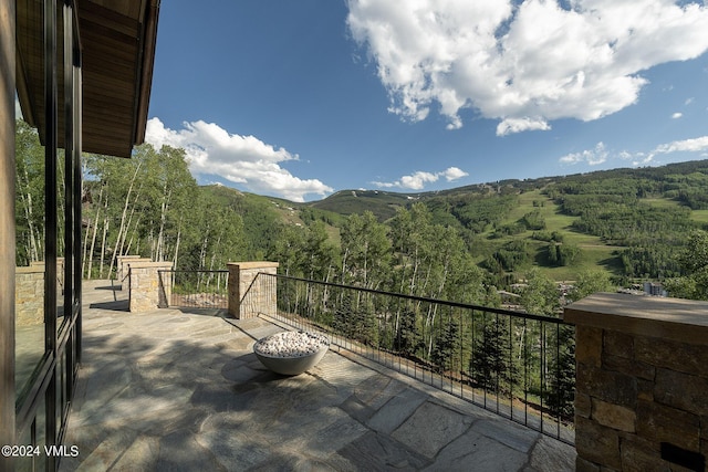 view of patio featuring a mountain view and a view of trees