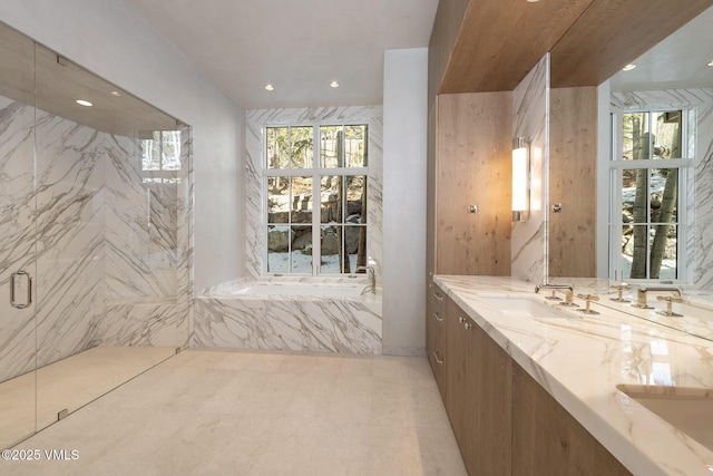 full bath featuring double vanity, a marble finish shower, a sink, and recessed lighting