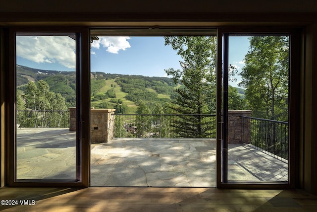 doorway to outside featuring a view of trees