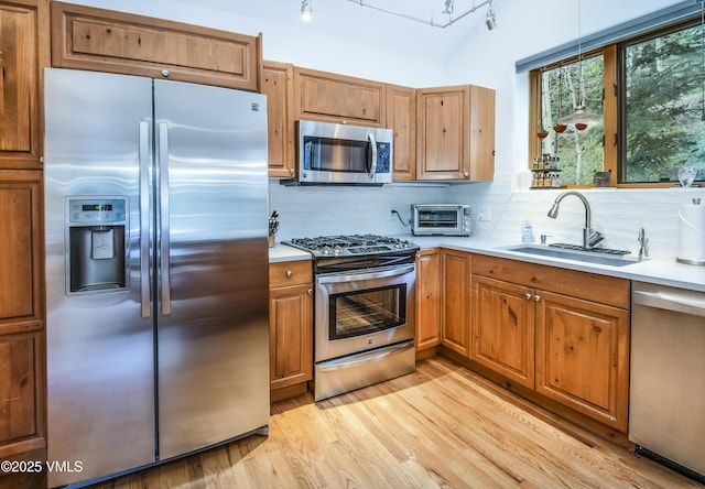 1460 Buffehr Creek Rd Unit C, Vail, CO 81657 - kitchen featuring stainless steel appliances, a sink, decorative backsplash, and light countertops