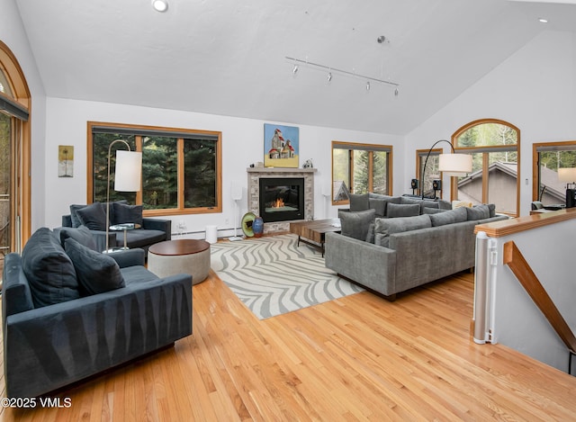 1460 Buffehr Creek Rd Unit C, Vail, CO 81657 - living room with wood-type flooring, rail lighting, a baseboard radiator, a glass covered fireplace, and recessed lighting