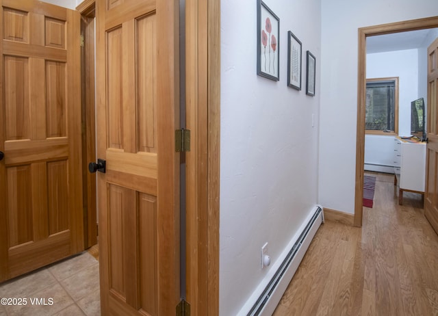 1460 Buffehr Creek Rd Unit C, Vail, CO 81657 - corridor featuring a baseboard heating unit, light wood-style flooring, and baseboards