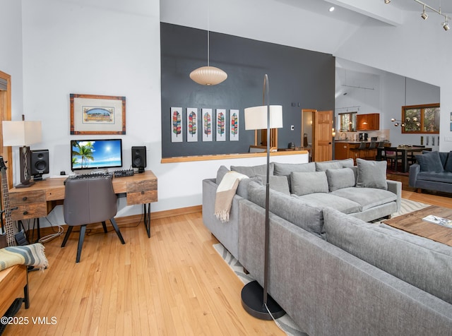 1460 Buffehr Creek Rd Unit C, Vail, CO 81657 - living room featuring high vaulted ceiling, hardwood / wood-style floors, and baseboards