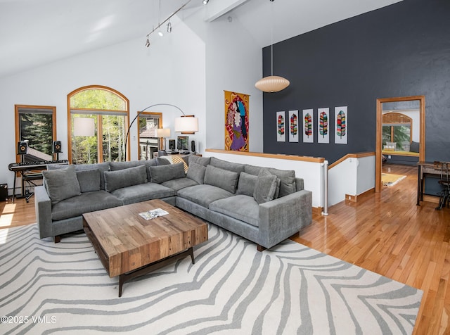 1460 Buffehr Creek Rd Unit C, Vail, CO 81657 - living room featuring wood finished floors, track lighting, and high vaulted ceiling