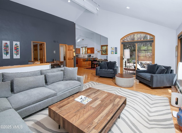 1460 Buffehr Creek Rd Unit C, Vail, CO 81657 - living area with light wood-type flooring, high vaulted ceiling, beamed ceiling, and rail lighting