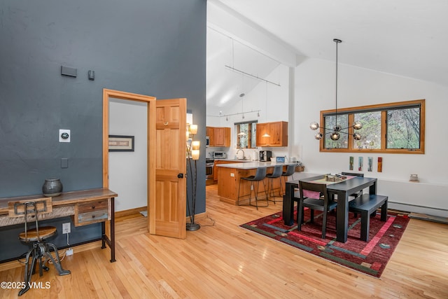 1460 Buffehr Creek Rd Unit C, Vail, CO 81657 - dining space featuring high vaulted ceiling, light wood-style floors, beamed ceiling, and baseboard heating