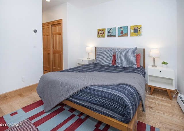 1460 Buffehr Creek Rd Unit C, Vail, CO 81657 - bedroom with wood finished floors, baseboards, and a baseboard radiator