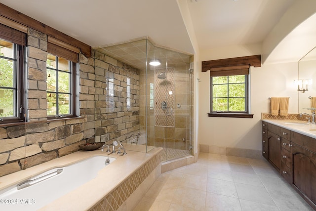 bathroom with vanity, independent shower and bath, and tile patterned flooring