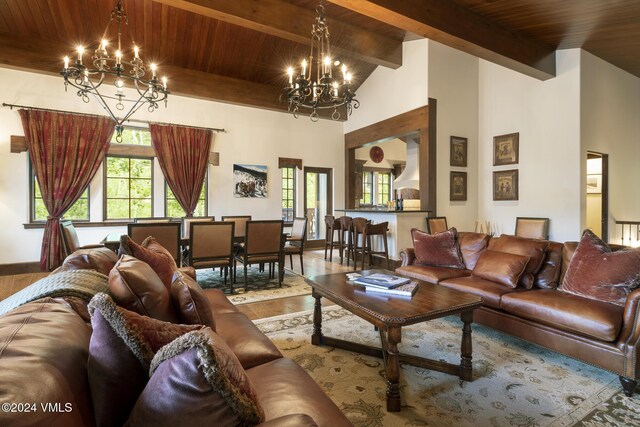 living room with high vaulted ceiling, beam ceiling, wooden ceiling, and a chandelier