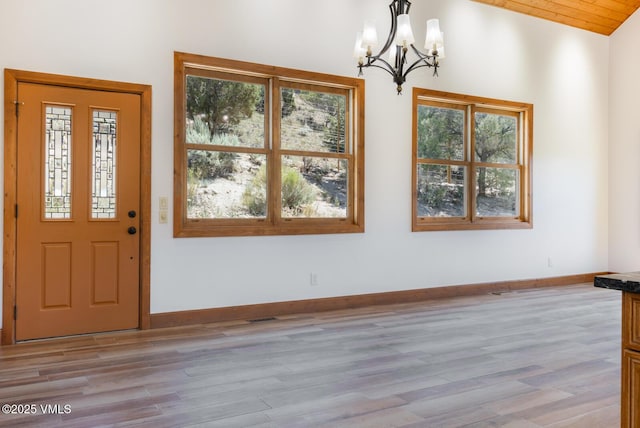 416 Eby Creek Rd, Eagle, CO 81631 - entryway featuring a chandelier, healthy amount of natural light, light wood-style flooring, and vaulted ceiling