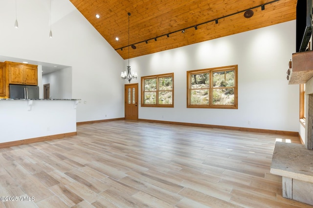 416 Eby Creek Rd, Eagle, CO 81631 - unfurnished living room with high vaulted ceiling, wooden ceiling, track lighting, a chandelier, and light wood-style floors