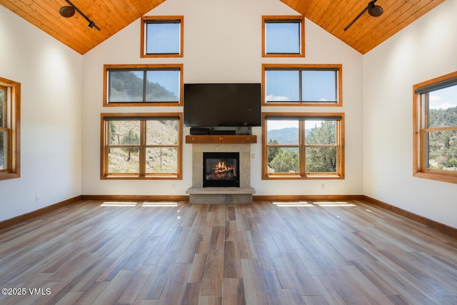 416 Eby Creek Rd, Eagle, CO 81631 - unfurnished living room with high vaulted ceiling, wooden ceiling, wood finished floors, and a glass covered fireplace