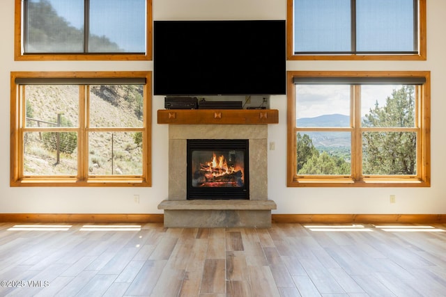 416 Eby Creek Rd, Eagle, CO 81631 - unfurnished living room with wood finished floors, a fireplace, and healthy amount of natural light