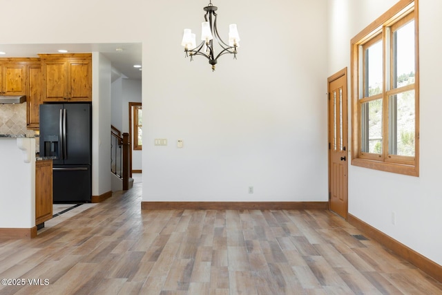 416 Eby Creek Rd, Eagle, CO 81631 - unfurnished dining area with a chandelier, light wood finished floors, recessed lighting, and stairway