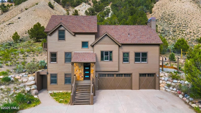 416 Eby Creek Rd, Eagle, CO 81631 - view of front of property with a garage, concrete driveway, a chimney, roof with shingles, and stairs