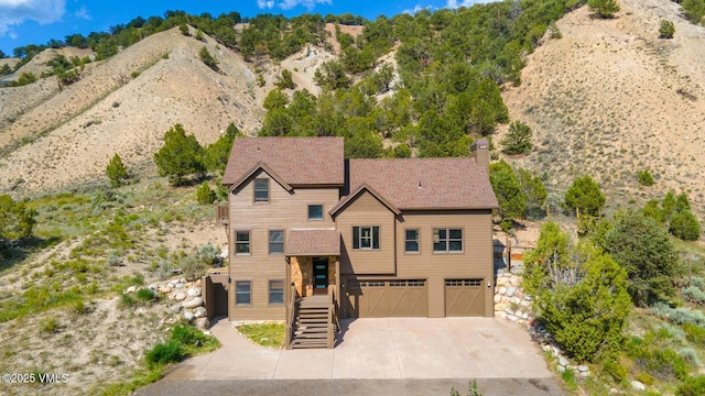 416 Eby Creek Rd, Eagle, CO 81631 - view of front of home featuring an attached garage, driveway, stairway, a chimney, and a mountain view