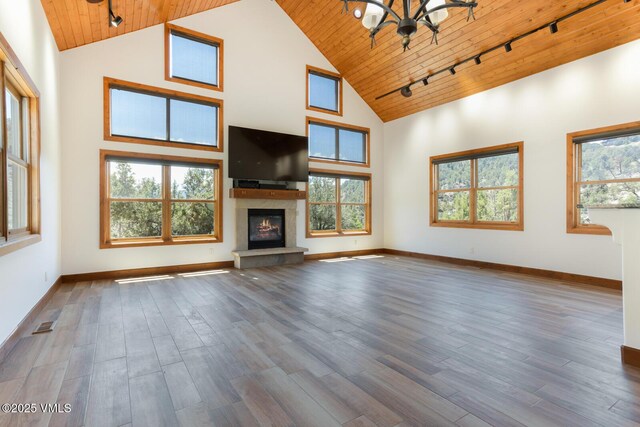 416 Eby Creek Rd, Eagle, CO 81631 - unfurnished living room featuring rail lighting, wood ceiling, high vaulted ceiling, a glass covered fireplace, and wood finished floors