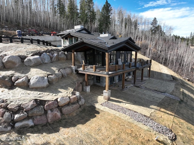 back of property with a wooden deck