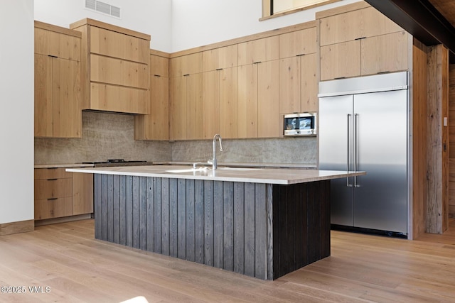 181 Black Bear Trl, Edwards, CO 81632 - kitchen with modern cabinets, visible vents, appliances with stainless steel finishes, a sink, and light brown cabinets