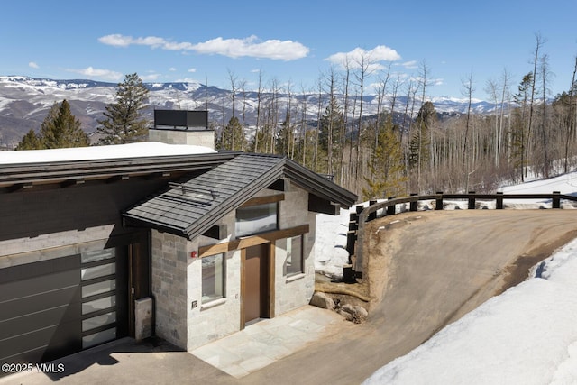 181 Black Bear Trl, Edwards, CO 81632 - exterior space featuring a mountain view, stone siding, and a chimney