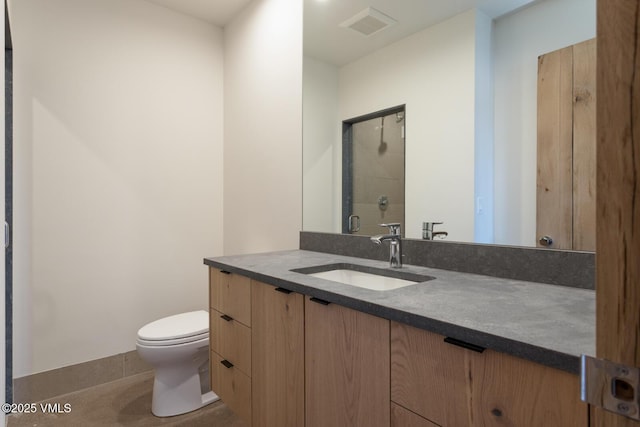 181 Black Bear Trl, Edwards, CO 81632 - bathroom featuring visible vents, toilet, a shower stall, vanity, and tile patterned flooring
