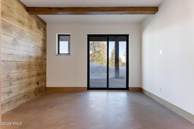 181 Black Bear Trl, Edwards, CO 81632 - spare room featuring beamed ceiling, wooden walls, baseboards, and concrete flooring