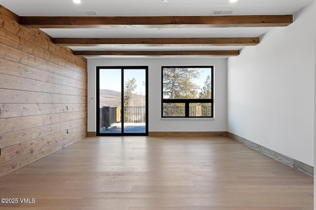 181 Black Bear Trl, Edwards, CO 81632 - spare room with wooden walls, visible vents, wood finished floors, and beamed ceiling
