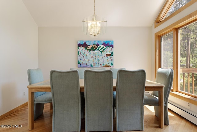 5159 Gore Cir, Vail, CO 81657 - dining space with a chandelier, a baseboard heating unit, light wood-type flooring, and vaulted ceiling