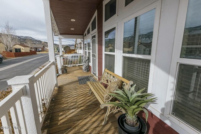 balcony featuring a mountain view and a porch