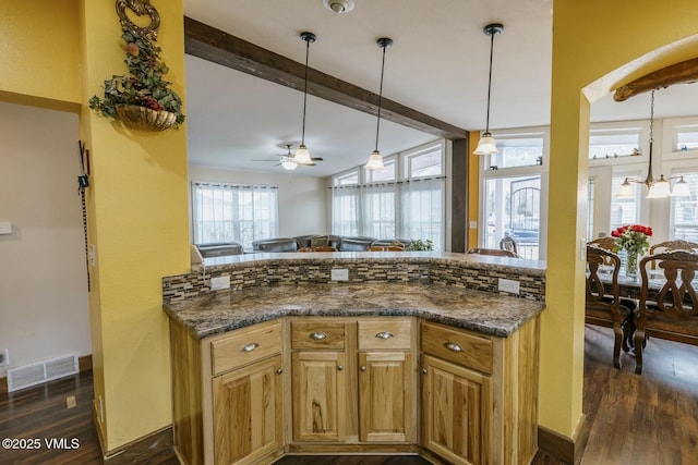 kitchen with dark wood finished floors, visible vents, beamed ceiling, and ceiling fan