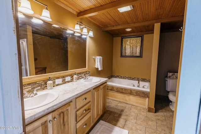 bathroom featuring tile patterned flooring, beam ceiling, a bath, and a sink
