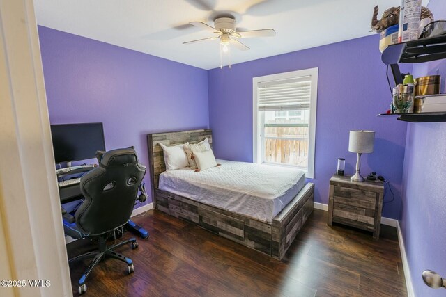 bedroom featuring wood finished floors, baseboards, and ceiling fan