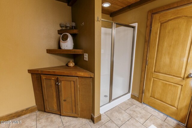 full bathroom with tile patterned floors and a stall shower